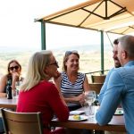 Expats socializing at a cafe in sunny Portugal.